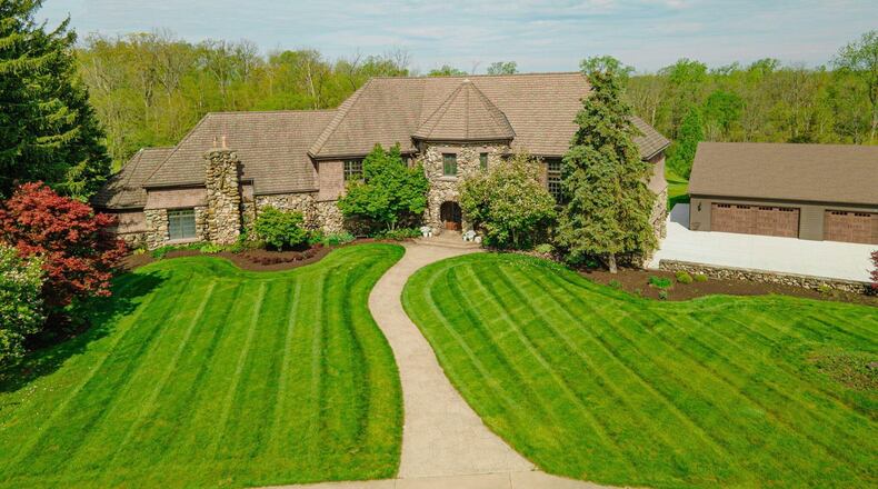 The front of the main residence has cedar siding and river rock. The front entry is covered and surrounded by river rock, and there are copper gutters and a clay tile roof. CONTRIBUTED PHOTOS