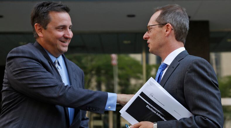 Attorney Nick Gounaris, left, talks with U.S. Attorney Benjamin Glassman after an Aug. 14 hearing in Federal Court for Gounaris’s client Ethan Kollie, who was charged with lying on a federal firearms form. Kollie was a friend of the Oregon District shooter. TY GREENLEES / STAFF