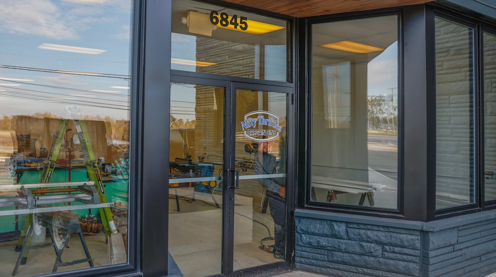 Josh Blake does construction on the upcoming Nifty Thrifties Bargain Bins on Friday, October 31, 2025, in Enon. The store is planned to open in November. JOSEPH COOKE/STAFF