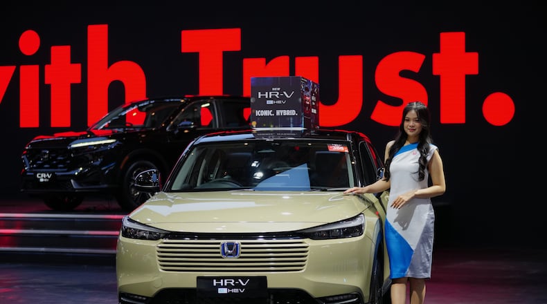 A model poses near a Honda HR-V car during the Indonesian International Motor Show in Jakarta, Indonesia, Thursday, Feb. 5, 2026. (AP Photo/Tatan Syuflana)
