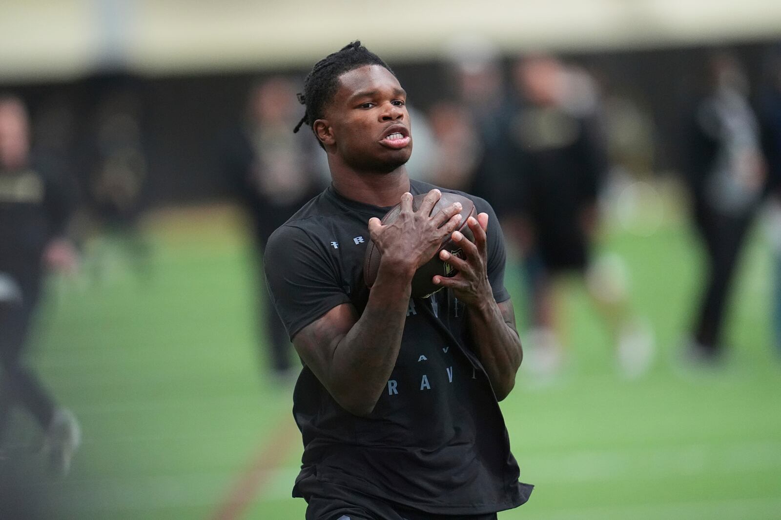 FILE - Colorado wide receiver Travis Hunter (12) takes part in passing drills during Colorado's NFL football pro day Friday, April 4, 2025, in Boulder, Colo. (AP Photo/David Zalubowsk,File)