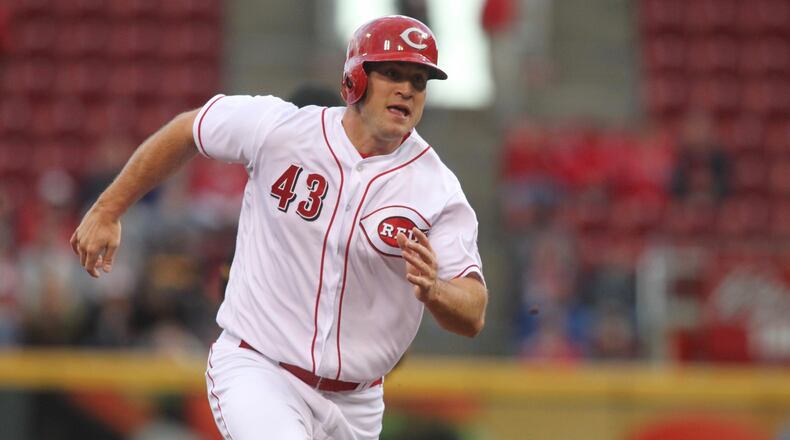 The Reds’ Scott Schebler runs to third base against the Pirates on Tuesday, May 2, 2017, at Great American Ball Park in Cincinnati. David Jablonski/Staff