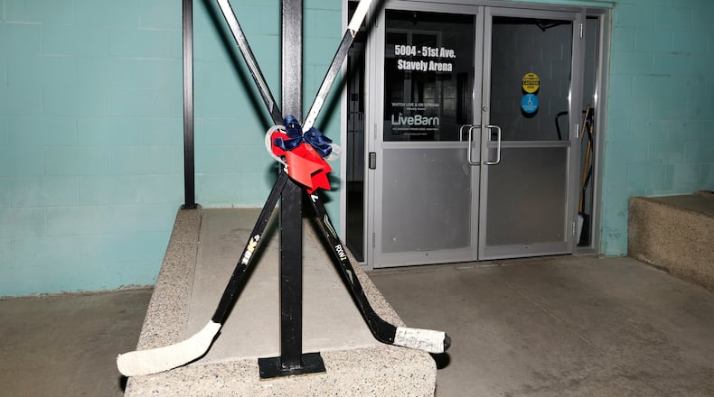 Crossed hockey sticks are shown outside of the Stavely Arena in Stavely, Alberta, Monday, Feb. 2, 2026. (Larry MacDougal/The Canadian Press via AP)