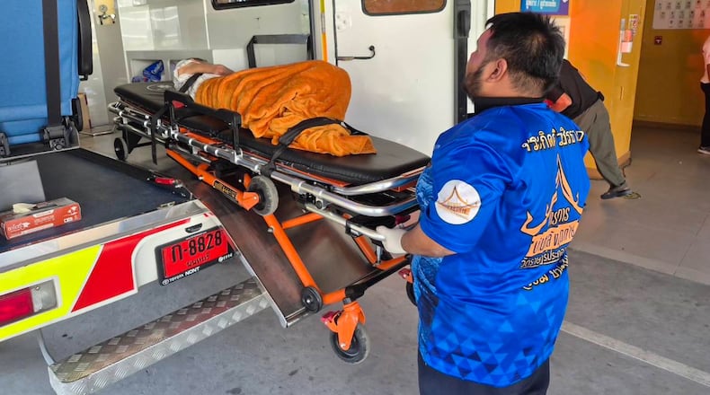 In this Sunday, Nov. 23, 2025, photo, an emergency rescue team transports an elderly woman discovered to still be alive after being considered deceased to a local hospital before her scheduled cremation at Wat Rat Prakhong Tham temple, Nonthaburi province, Thailand. (Wat Rat Prakhong Tham via AP)