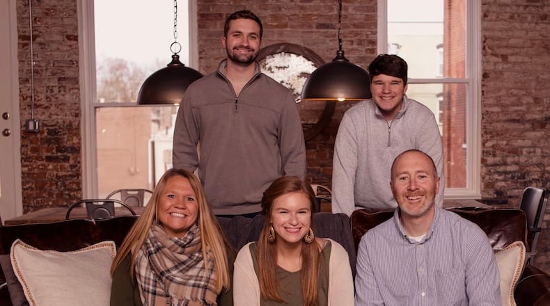 Sarah Pelphrey, bottom left, was nominated as a Dayton Daily News Community Gem. She's pictured here in her downtown Miamisburg loft with her family: sons Dane and Shane, upper left and upper right, daughter Tristen, bottom center, and husband Brian, bottom right. CONTRIBUTED