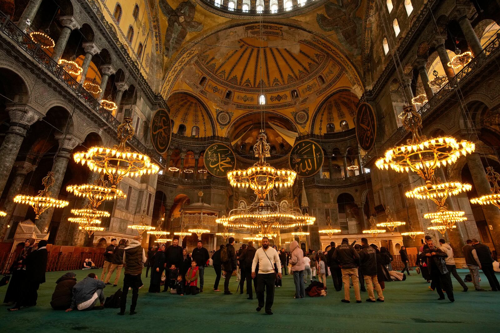People visit Byzantine-era Hagia Sophia mosque, in Istanbul, Turkey, Sunday, April 13, 2025. (AP Photo/Emrah Gurel)