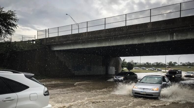 U.S. 35  is covered with high water following heavy rains  near James H. McGee in Dayton. STAFF PHOTO/Jim Noelker