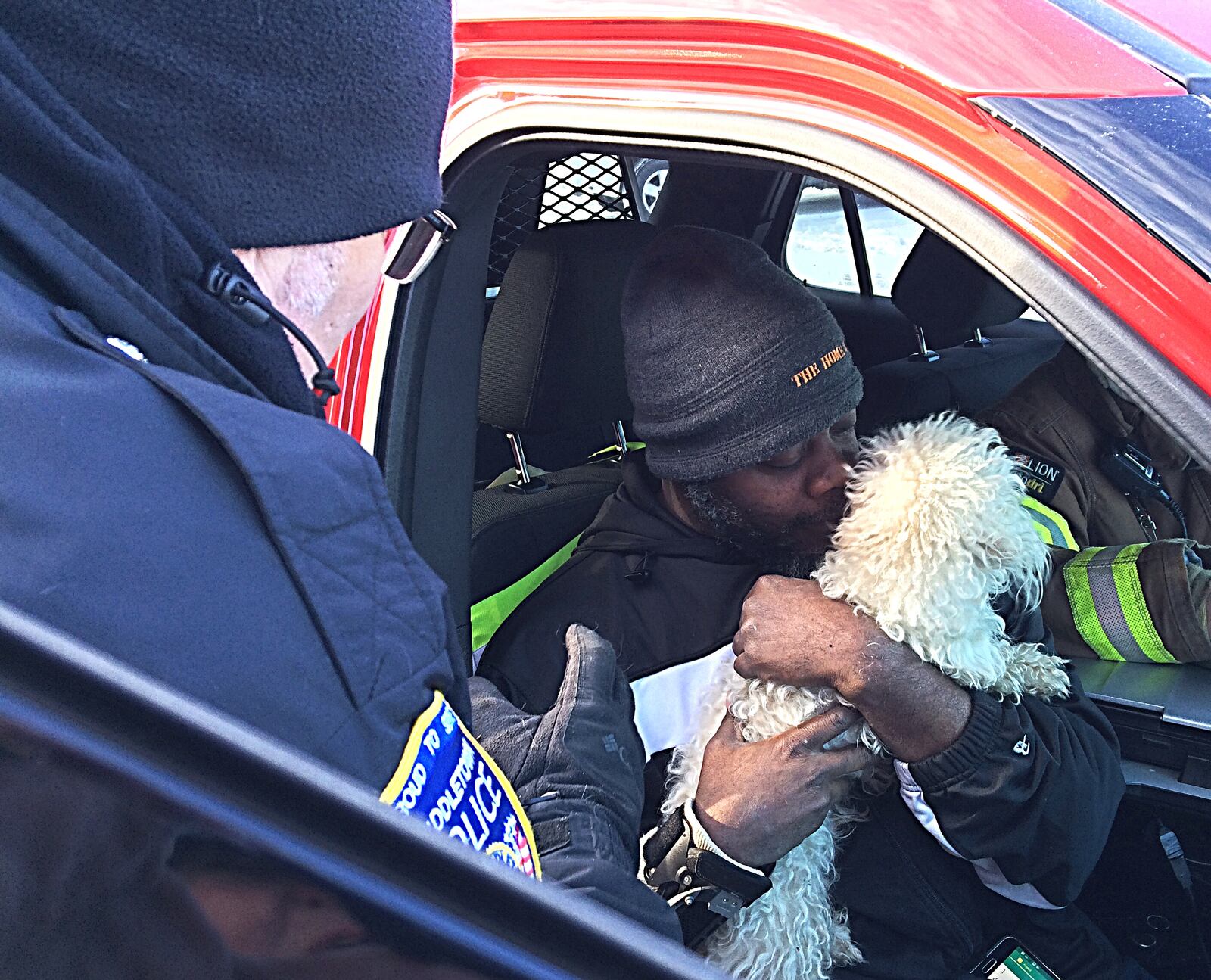 Kevin Gordon, hugs his dog Leo, after Middletown Division of Fire rescued the dog from Gordon Home. Photo by Marshall Gorby