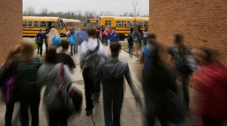 Traffic could become a problem as a key intersection in Clearcreek Twp. will be closed for 20 weeks to construct a new roundabout, forcing changes to Springboro bus routes to Five Points Elementary School. FILE PHOTO
Students at Springboro Junior High School head to the buses Dec. 6. Springboro schools are resuming busing of high school students in January after several years without the service.