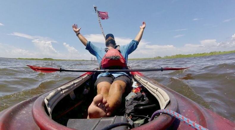 Andy Gallatin savors his arrival in August in the Gulf of Mexico, south of New Orleans, during his 3,000-mile kayak trip. COURTESY OF ANDY GALLATIN