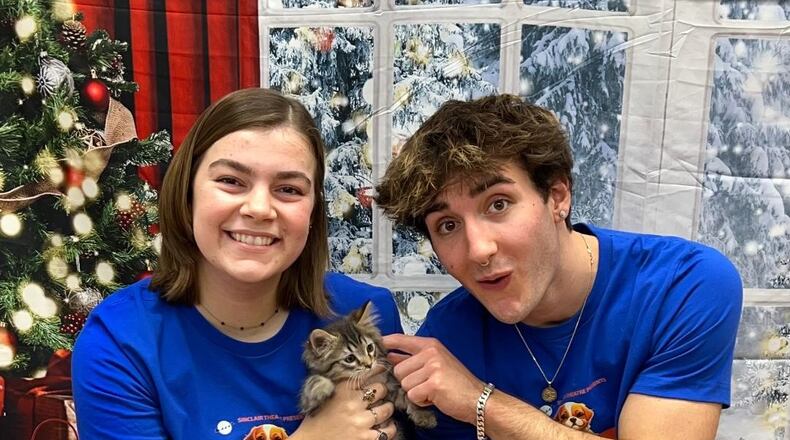 Amelie De la Nuez as Kia, the cat, and Ethan Harris as Duffy, the dog, get character development tips at the Humane Society on becoming rescue animals for their roles in Sinclair Theatre's "'Twas the Night Before Christmas and We're Home Alone!" in Blair Hall Dec. 14-17. PHOTO BY PATTI CELEK