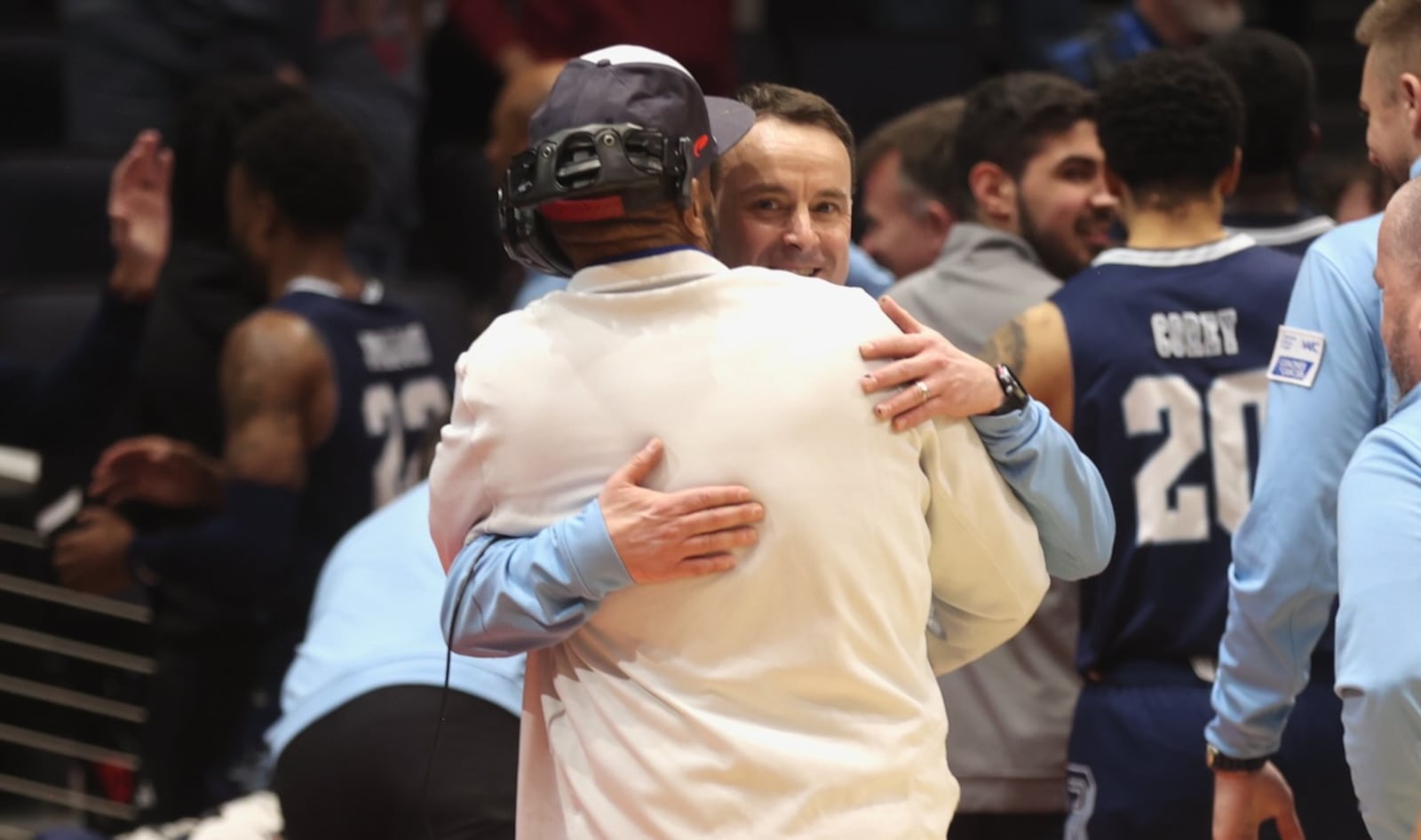 Rhode Island's Archie Miller hugs Willie Morris, of the Flyer Pep Band, after a game against Dayton on Tuesday, Jan. 27, 2026, at UD Arena. David Jablonski/Staff