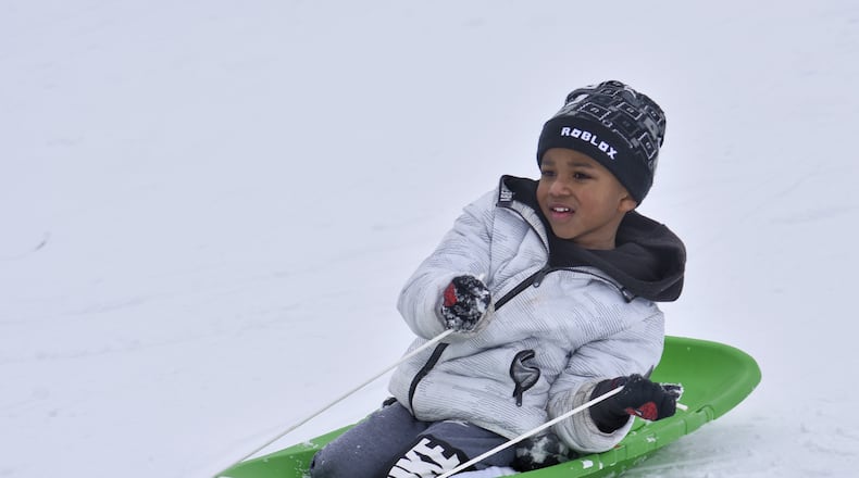 Amir Sheafe, 4, sleds down a hill at Voice of America MetroPark Thursday, February 18, 2021 in West Chester Township. Many schools in the area were off for a snow day. NICK GRAHAM / STAFF