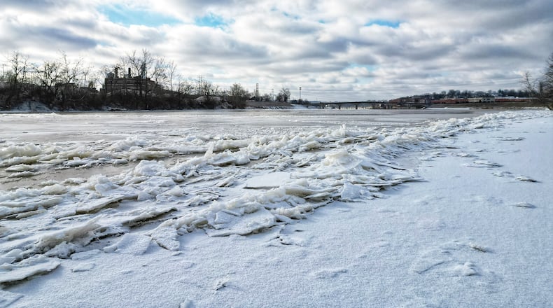 Ice forms on the surface of the Great Miami River at Combs Park in Hamilton Tuesday, Jan. 16, 2024, after several days of below freezing temperatures. NICK GRAHAM/STAFF