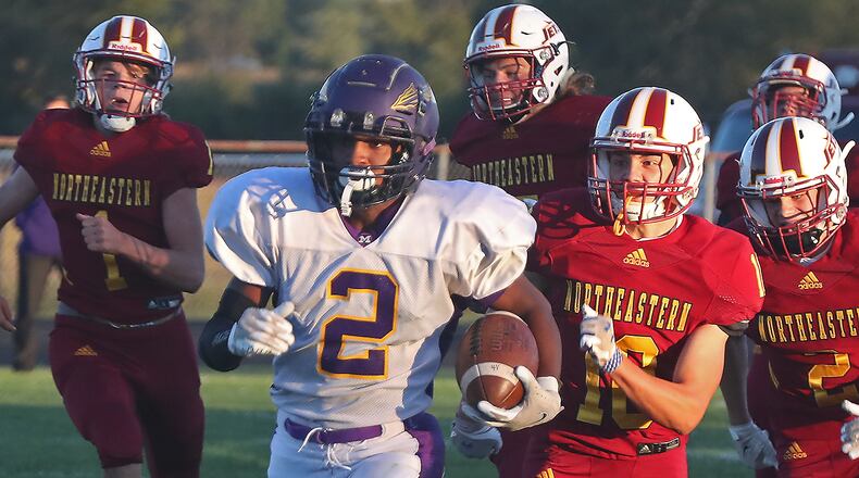 Mechanicsburg's Keith Bebout outruns a pack of Northeastern defenders as he carries the ball for a touchdown. BILL LACKEY/STAFF