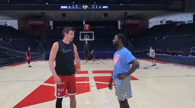 A.J. Pacher and Scoochie Smith talk near center court at UD Arena Saturday afternoon before the first TBT practice for their Red Scare team, Tom Archdeacon/CONTRIBUTED
