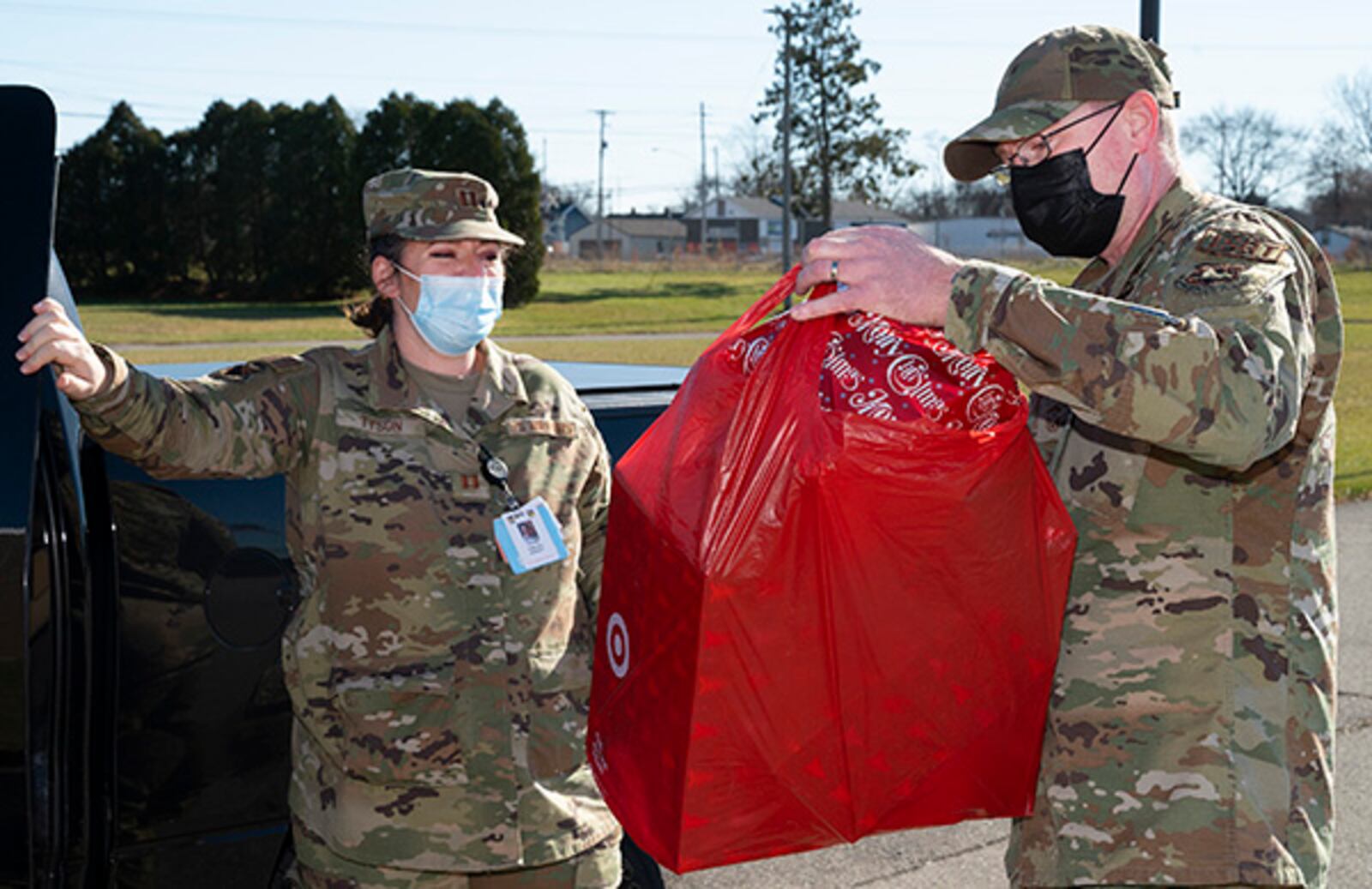 Senior Master Sgt. Timothy Sigafoos, National Air and Space Intelligence Center first sergeant, receives donated gifts from Capt. Chelsea Tyson, 88th Medical Group, for the First Sergeants Council’s Adopt-A-Family Program on Dec. 3 at Wright-Patterson Air Force Base. U.S. AIR FORCE PHOTO/R.J. ORIEZ