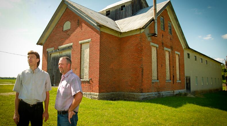 Co-owners Mark Zdobinski left, and Jim Meeks have purchased a one-room schoolhouse that dates back to 1890, planted 1,000 grapevines in the farm fields behind it, and will open the Olde Schoolhouse Vineyard & Winery next spring in Eldorado. JIM WITMER/STAFF