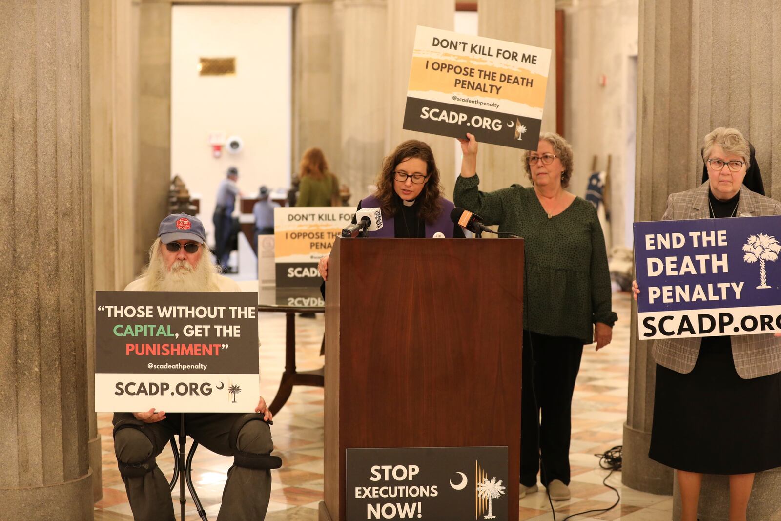 Members of South Carolinians for Alternatives to the Death Penalty speak before presenting petitions to South Carolina Gov. Henry McMaster asking him to grant clemency to Mikal Mahdi before his firing squad execution during a news conference on Thursday, April 10, 2025, in Columbia, S.C. (AP Photo/Jeffrey Collins)