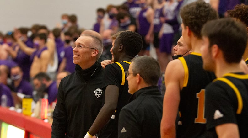 Centerville coach Brook Cupps smiles as he and his team watch the final seconds tick off the clock in Wednesday night's Division I region semifinal at Princeton High School. The Elks defeated Elder 52-43. Jeff Gilbert/CONTRIBUTED