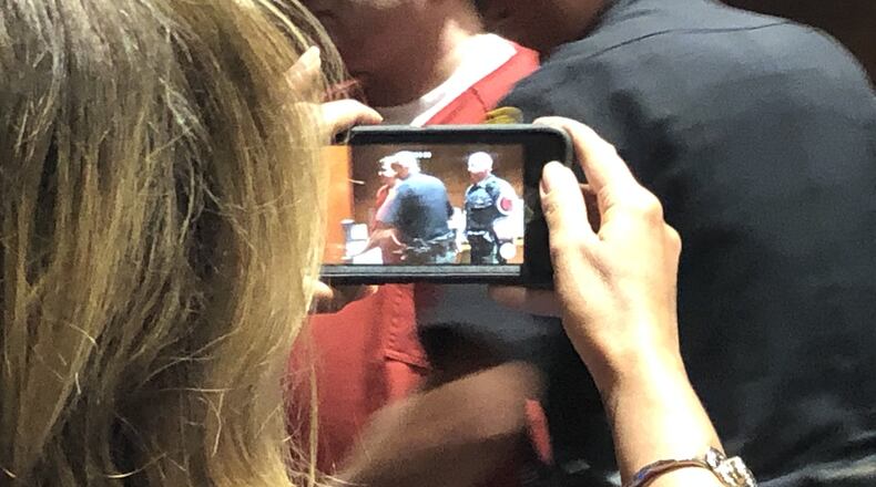 John Austin Hopkins led off to jail and then prison after his conviction for gross sexual imposition on first-grade girls during his gym class in Springboro. STAFF/LAWRENCE BUDD