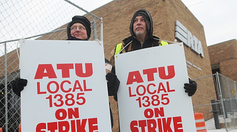 Elizabeth and Mike Hecker, both union employees of RTA, walk the picket line Monday at the Longworth Street Garage. STAFF PHOTO/MARSHALL GORBY