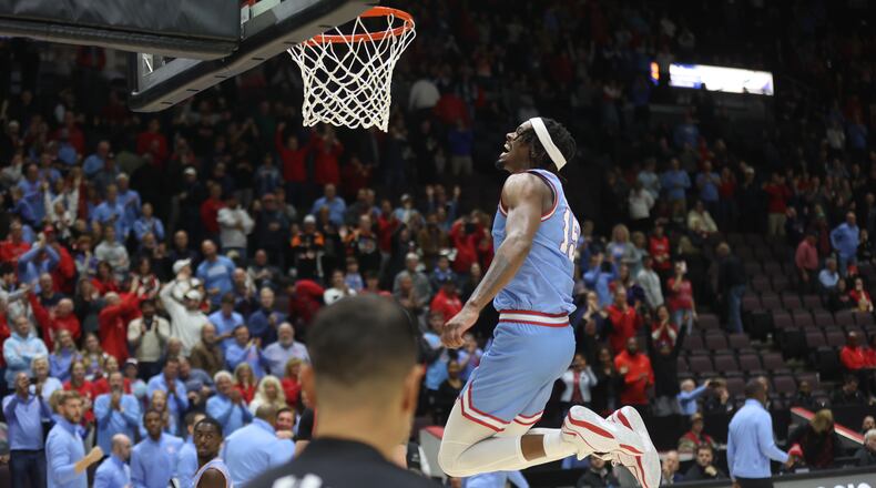 Dayton's DaRon Holmes II celebrates a victory against Cincinnati on Saturday, Dec. 16, 2023, at the Heritage Bank Center in Cincinnati. David Jablonski/Staff