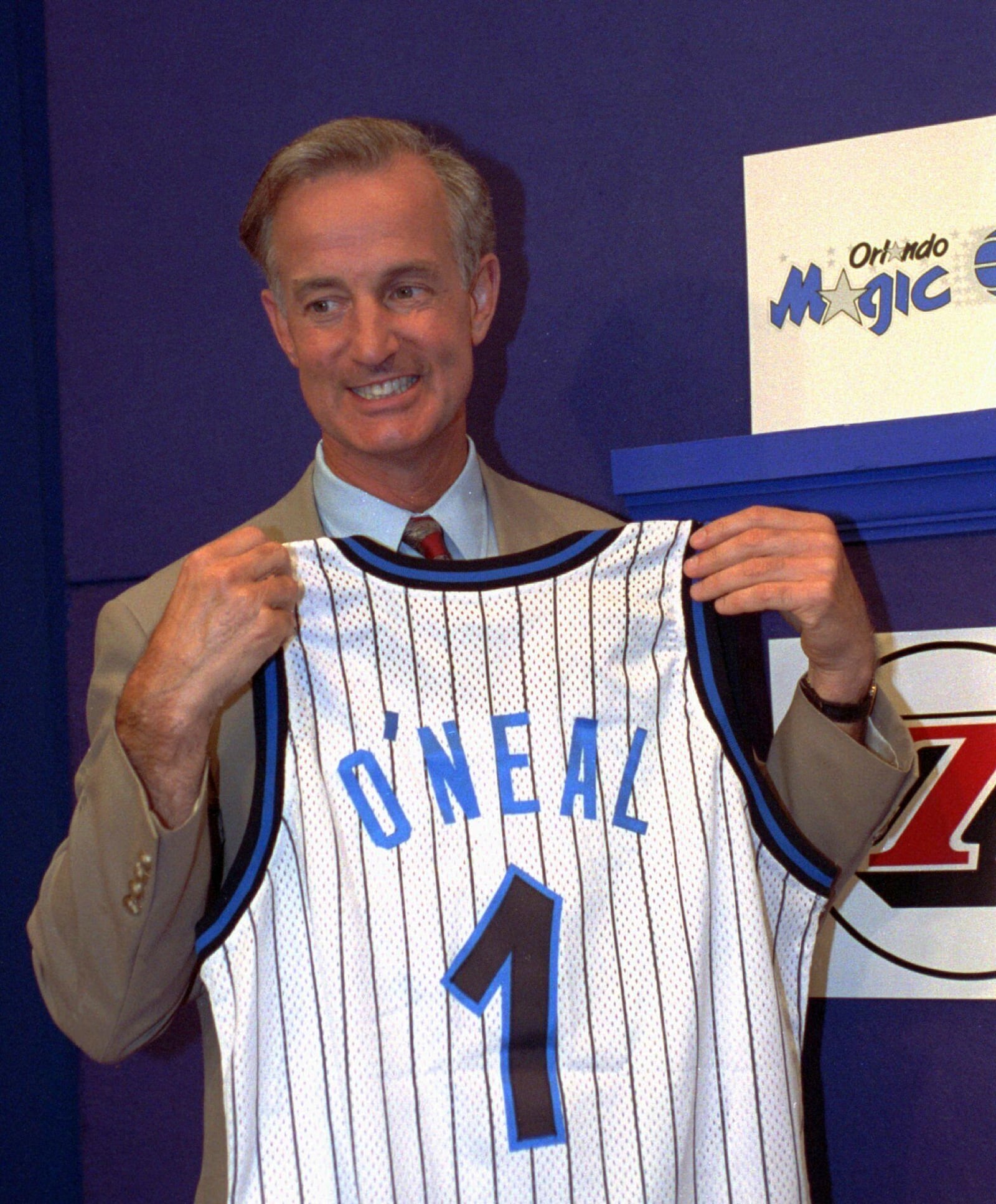 FILE - Orlando Magic President and General manager Pat Williams grins while holding up a jersey bearing the name O'Neal and the number 1, at the NBA draft lottery in Secaucus, N.J. May 17, 1992. (AP photo/Bill Kostroun, File)