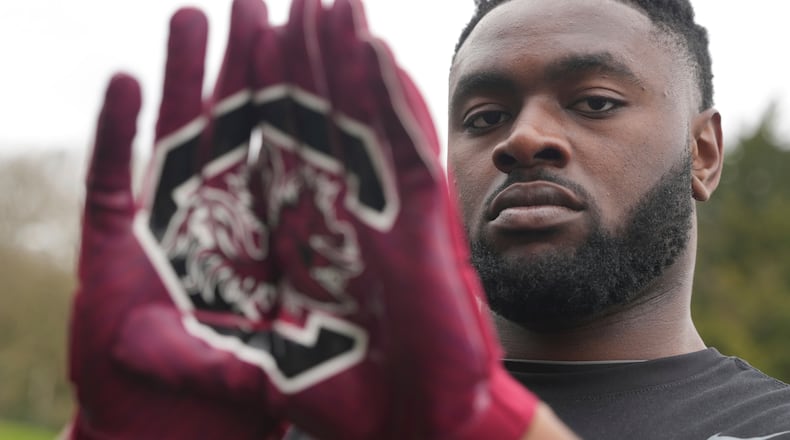 Oluwanifemi 'Neff' Giwa wears South Carolina 'Gamecocks" gloves as he takes part in a football workout session at the National Sports Center, Crystal Palace in London, Sunday, March 29, 2026. (AP Photo/Alastair Grant)