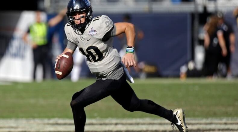 Central Florida quarterback McKenzie Milton scrambles during the second half of the American Athletic Conference championship NCAA college football game against Memphis, Saturday, Dec. 2, 2017, in Orlando, Fla. Central Florida won in overtime 62-55. (AP Photo/John Raoux)