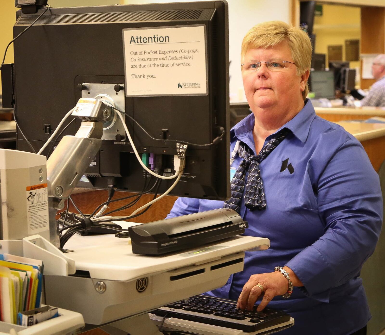 Donna Bush, Patient Financial Counselor at Kettering Medical Center enters data in the Emergency Department. Kettering Health Network tries to prevent people fraudulently obtaining medical care using stolen identities. They request to take a picture of people who present at the emergency room - although it is voluntary. They also ask a variety of questions to see if the information the patient gives matches what the electronic record shows for the person is claiming to be. JIM WITMER/STAFF