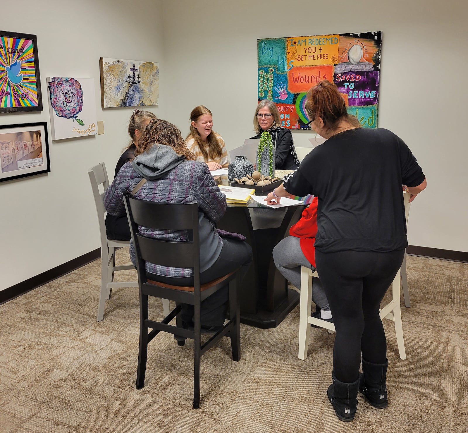 Dona Pierce (pictured center) is executive director of Oasis House. 
Contributed.