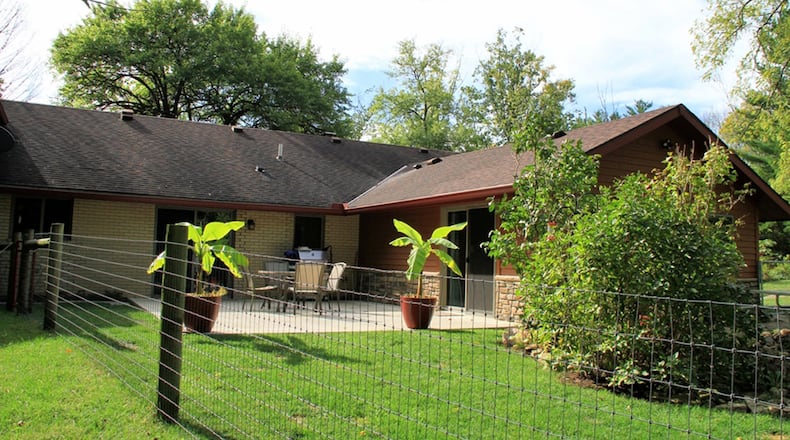 Patio doors off the first-floor main bedroom and the breakfast room open to a concrete patio and fenced backyard.