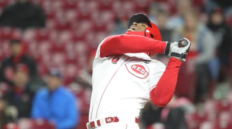 The Reds’ Yasiel Puig pops up for the final out of a loss to the Brewers on Monday, April 1, 2019, at Great American Ball Park in Cincinnati.