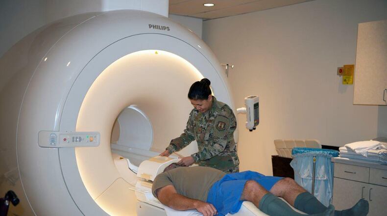 The 88th Medical Group’s Magnetic Resonance Imaging Technologists Tech. Sgt. Mariechrist Shuty (right) and Tech. Sgt. Timothy Carlson demonstrate how to properly and safely prepare a patient for an MRI of a patient’s head at Wright-Patterson Medical Center Sept. 18. The Diagnostic Imaging Flight’s MRI section performs more than 5,000 patient scans a year to assist doctors with treating patients. (U.S. Air Force photo/Leticia Hopkins)
