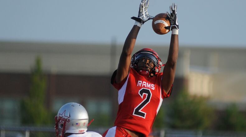 Trotwood’s Dallas Daniels goes for a catch over Kobe Feltner. Trotwood-Madison defeated Troy 48-0 in a Week 1 high school football game on Friday, Aug. 25, 2017. MARC PENDLETON / STAFF