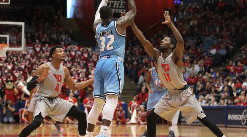 Rhode Island’s Jared Terrell, center, passes against Dayton’s Charles Cooke, left, and Scoochie Smith on Saturday, Feb. 27, 2016, at UD Arena in Dayton. David Jablonski/Staff