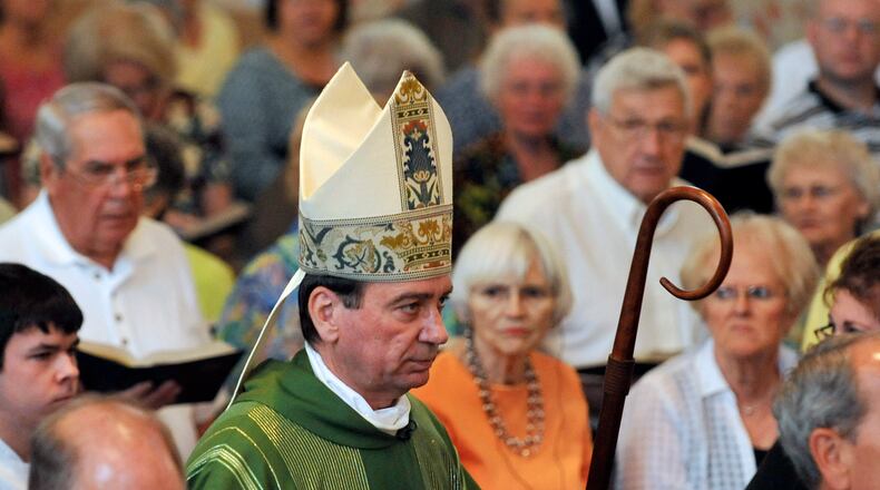 Archbishop Dennis Schnurr walks with the processional during the start of mass. Staff photo by Bill Lackey