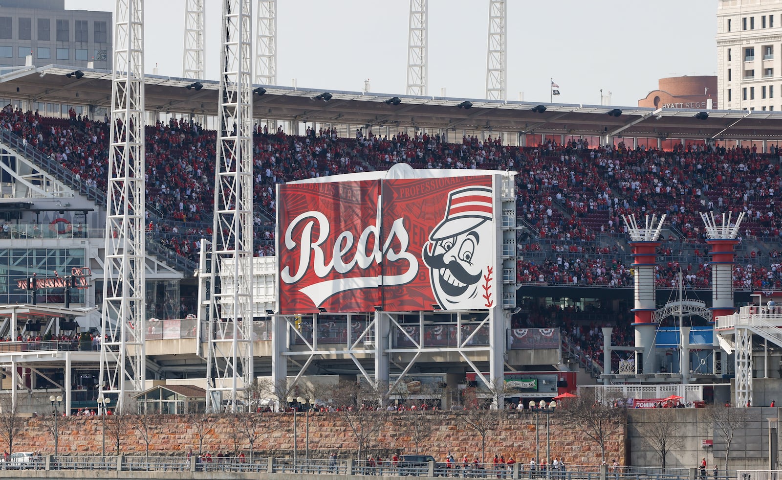 Three Apache helicopters and one Blackhawk helicopter flew over Great American BallPark to kick off the season for the Cincinnati Reds on opening day Thursday, March 26, 2026 in Cincinnati. NICK GRAHAM/STAFF