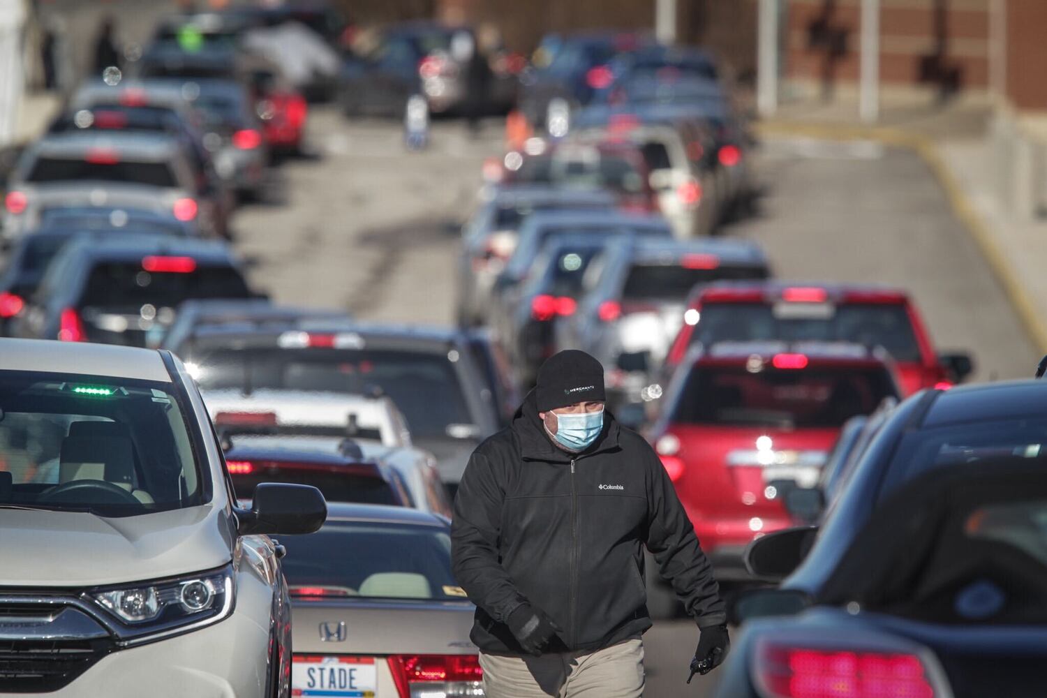Cars line up for a coronavirus vaccine clinic at UD Arena