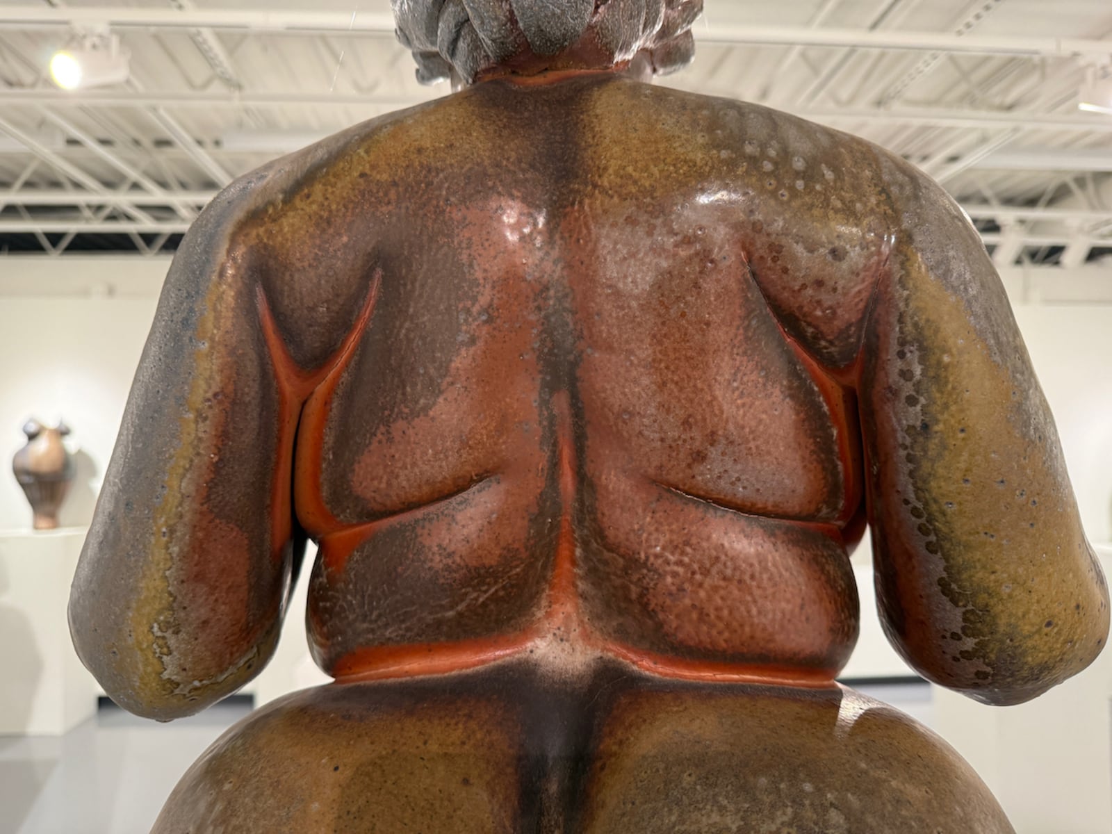 Detail of a wood-fired stoneware Venus figure by Denny Gerwin, sculpted from clay, on view at Rosewood's art gallery. His take on the 30,000 year old fertility symbol oscillates between abstracted vessels and sculpted realism, endowing his clay with embodied qualities — folds, curves, heavy breasts and full thighs. HANNAH KASPER/CONTRIBUTED