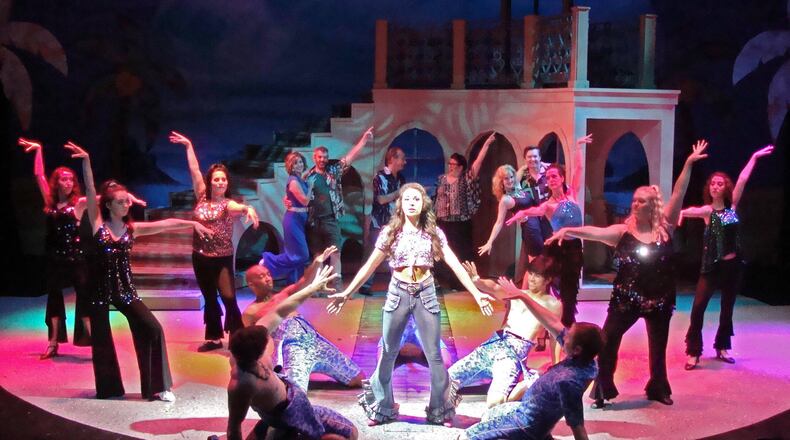 Erica Lynn Bridge (center) and the cast of La Comedia Dinner Theatre’s production of the musical Mamma Mia!, featuring a slew of hits from 1970s pop icons ABBA. CONTRIBUTED PHOTO