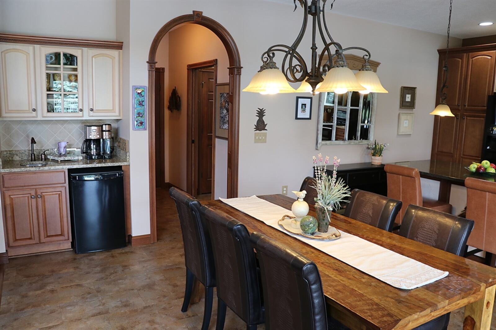 Tucked off the dining area is a wet bar with a preparation sink and appliance nook. 