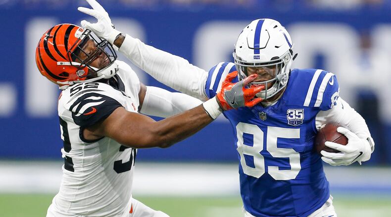 Cincinnati Bengals linebacker Preston Brown (52) tries to bring down Indianapolis Colts tight end Eric Ebron (85) on this first half play on Sunday, Sept. 9, 2018 at Lucas Oil Stadium in Indianapolis, Ind. (Sam Riche/TNS)