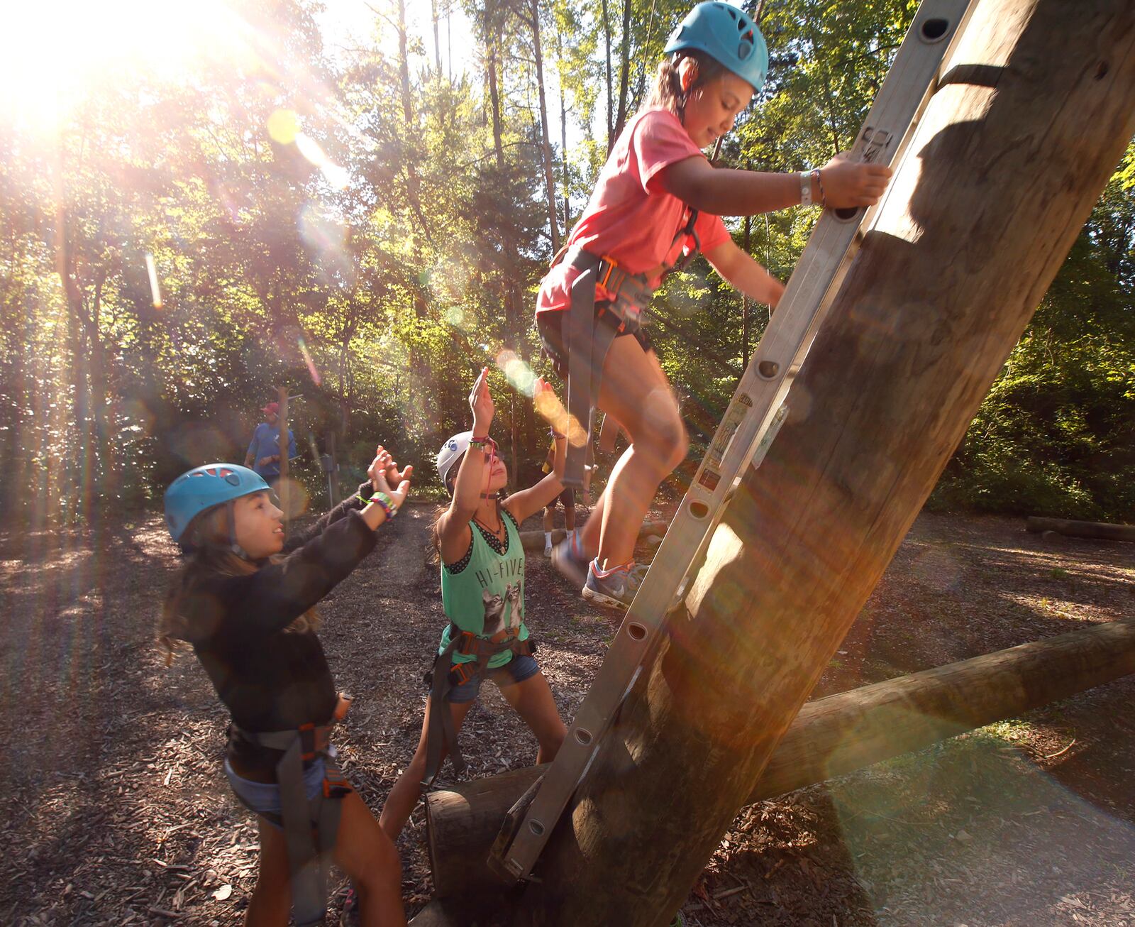 Fellow campers spot Lilly Gautraud as she climbs Tango Tower at Camp Kern.   TY GREENLEES / STAFF