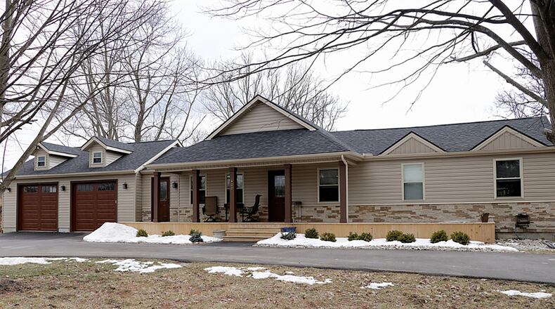 The 3-bedroom home with about 1,720 sq. ft. of living space sits on just over a half-acre lot surrounded by mature trees and creek with a paved circular driveway, a covered front deck and a 2-car garage with rear service door and storage. CONTRIBUTED PHOTO BY KATHY TYLER