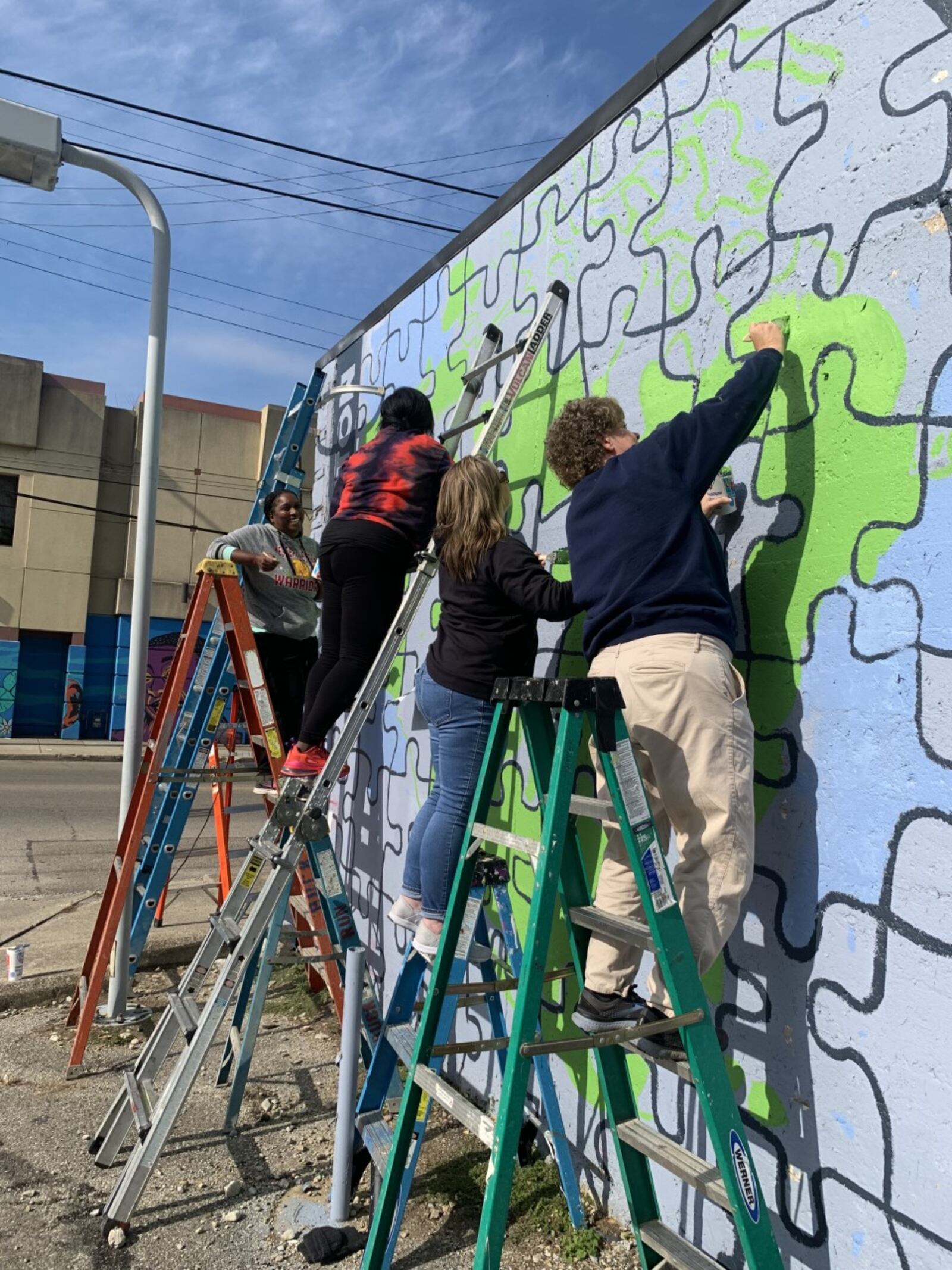 Local students and members of the Montgomery County Prevention Coalition work on a suicide prevention mural. CONTRIBUTED