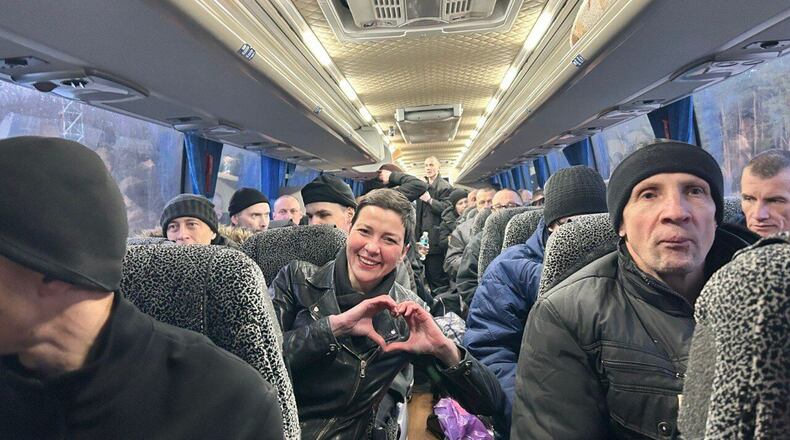 In this photo provided by the Press Service Of Coordination Headquarters for the Treatment of Prisoners of War on Saturday, Dec 13, 2025, Maria Kolesnikova, key Belorussian opposition figure, shows a sign of love siting in a bus after been released from detention in Belarus, at the Ukrainian Belorussian border. (Press Service Of Coordination Headquarters for the Treatment of Prisoners of War via AP)