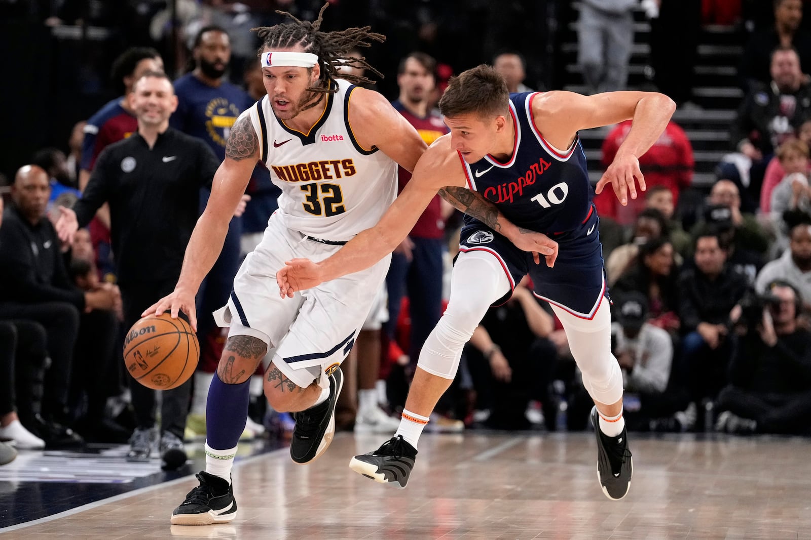 Denver Nuggets forward Aaron Gordon, drives the court while under pressure from Los Angeles Clippers guard Bogdan Bogdanovic during the second half in Game 4 of an NBA basketball first-round playoff series Saturday, April 26, 2025, in Inglewood, Calif. (AP Photo/Mark J. Terrill)