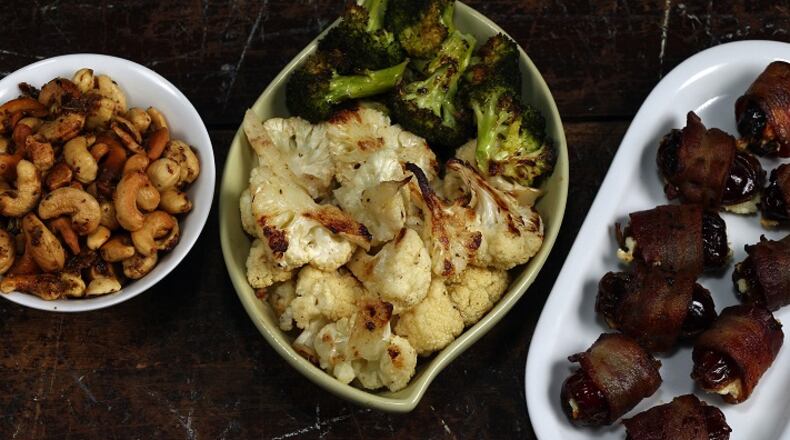 Three of the beer snack choices: beer nuts, from left, garlic and anchovy-roasted cauliflower and broccoli, and cheese-filled, bacon-wrapped dates. (Terrence Antonio James/Chicago Tribune/TNS)